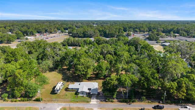 birds eye view of property featuring a wooded view