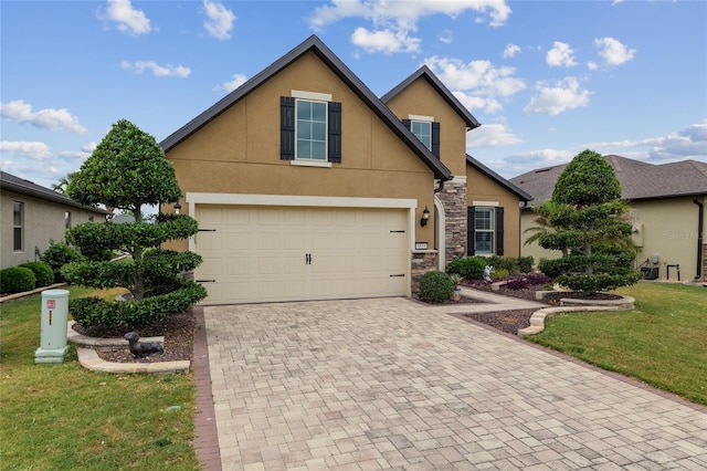 6816 SW 95th Cir, Ocala, FL 34481 - view of front of home with stone siding, an attached garage, a front yard, stucco siding, and decorative driveway