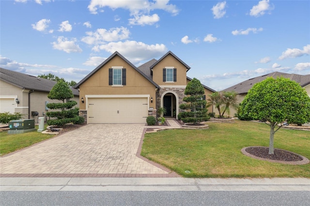 6816 SW 95th Cir, Ocala, FL 34481 - view of front of property featuring decorative driveway, stone siding, stucco siding, and a garage