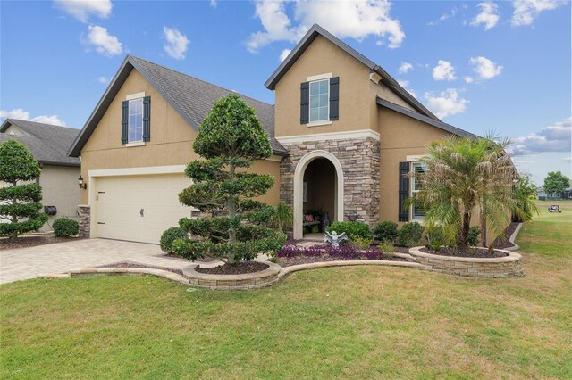 6816 SW 95th Cir, Ocala, FL 34481 - view of front of property featuring a front lawn, driveway, stone siding, a garage, and stucco siding