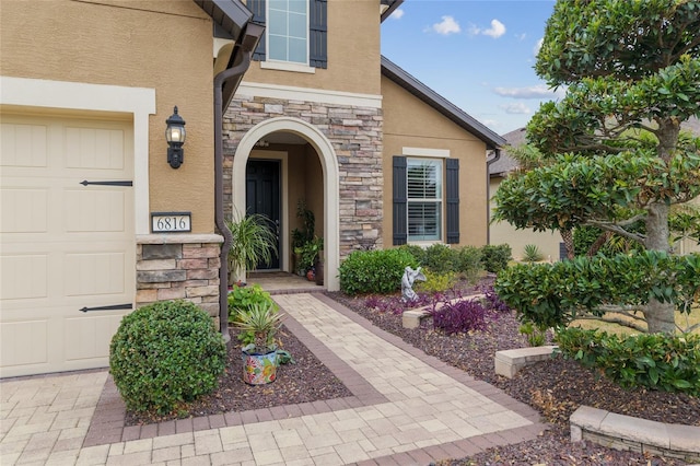 6816 SW 95th Cir, Ocala, FL 34481 - doorway to property featuring stone siding, an attached garage, and stucco siding