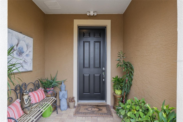 6816 SW 95th Cir, Ocala, FL 34481 - doorway to property featuring visible vents and stucco siding