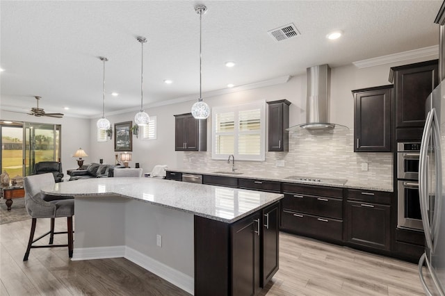 6816 SW 95th Cir, Ocala, FL 34481 - kitchen featuring a center island, a sink, open floor plan, wall chimney exhaust hood, and visible vents