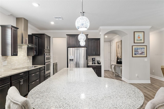 6816 SW 95th Cir, Ocala, FL 34481 - kitchen with wall chimney range hood, arched walkways, stainless steel appliances, light wood-style flooring, and visible vents