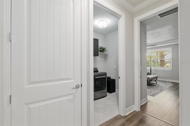 6816 SW 95th Cir, Ocala, FL 34481 - corridor with wood finished floors, a textured ceiling, baseboards, ornamental molding, and visible vents