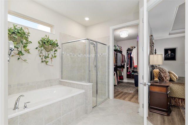 6816 SW 95th Cir, Ocala, FL 34481 - full bath featuring a garden tub, tile patterned flooring, a shower stall, and a spacious closet