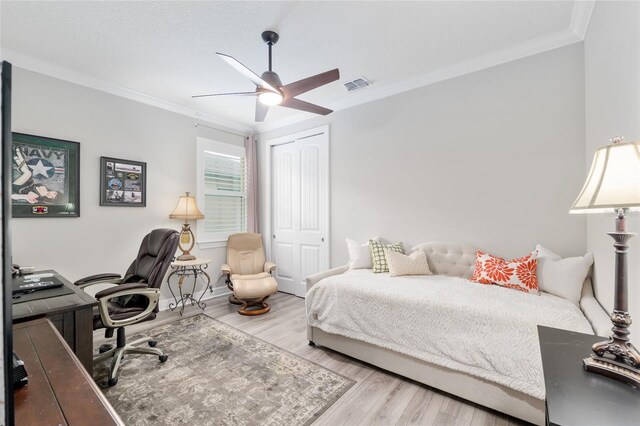 6816 SW 95th Cir, Ocala, FL 34481 - bedroom featuring wood finished floors, visible vents, a closet, and ornamental molding