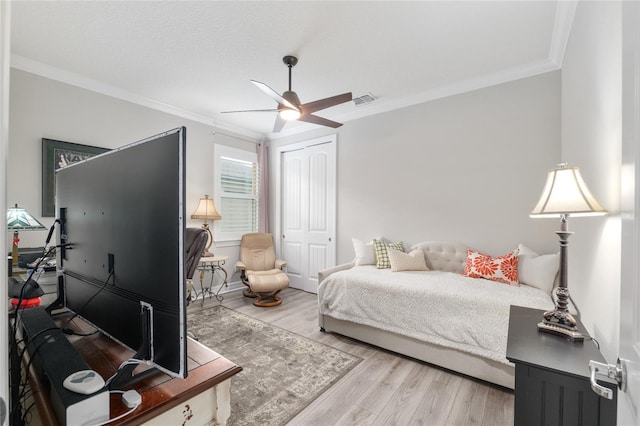 6816 SW 95th Cir, Ocala, FL 34481 - bedroom with light wood finished floors, visible vents, a closet, and ornamental molding