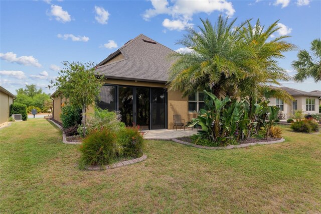 6816 SW 95th Cir, Ocala, FL 34481 - back of house with a patio area, roof with shingles, a yard, and stucco siding