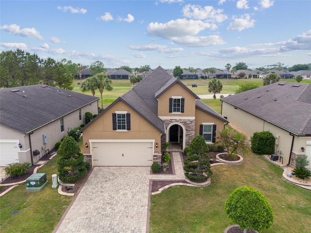 6816 SW 95th Cir, Ocala, FL 34481 - traditional-style house featuring stucco siding, a front lawn, driveway, and stone siding