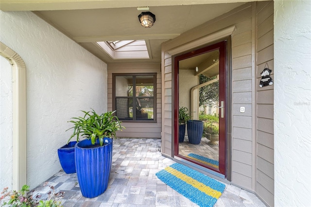 property entrance with stucco siding