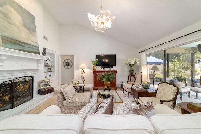 living area featuring visible vents, an inviting chandelier, a fireplace with raised hearth, built in shelves, and wood finished floors