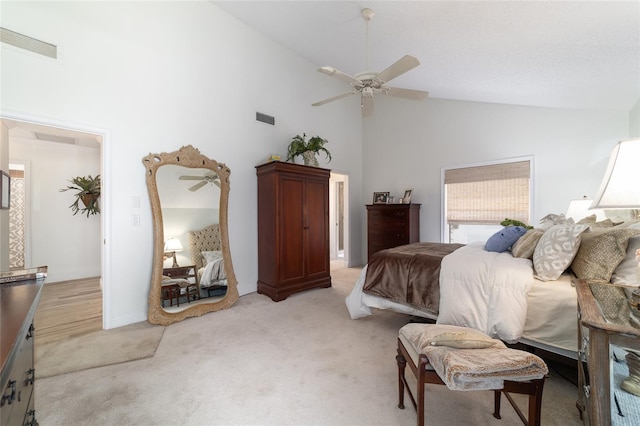 bedroom with high vaulted ceiling, light carpet, a ceiling fan, and visible vents