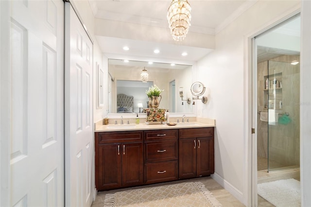 full bathroom with a shower stall, an inviting chandelier, a sink, and double vanity