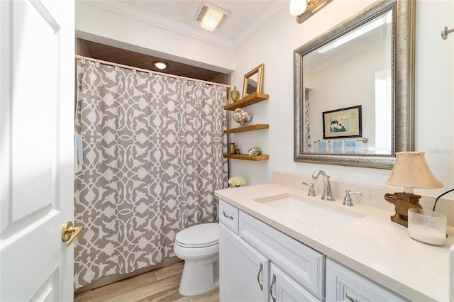 bathroom featuring toilet, visible vents, wood finished floors, vanity, and ornamental molding