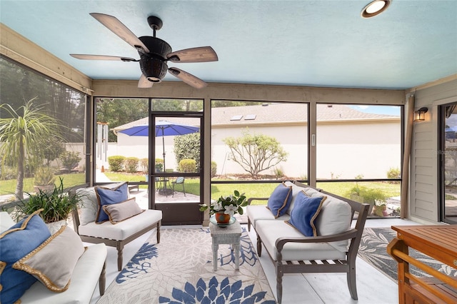 sunroom featuring an outdoor living space and a ceiling fan