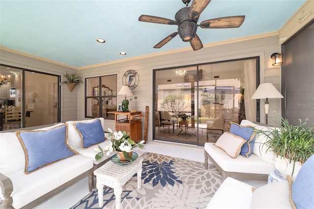 living room featuring ceiling fan with notable chandelier, recessed lighting, and crown molding