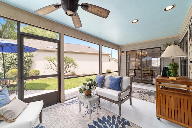 sunroom / solarium with an outdoor living space and ceiling fan