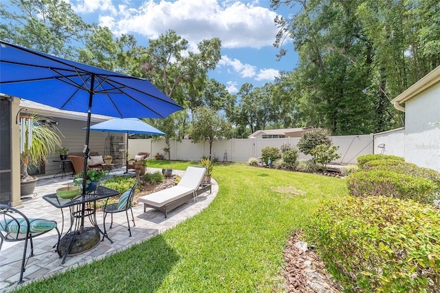 view of yard featuring a patio area and a fenced backyard