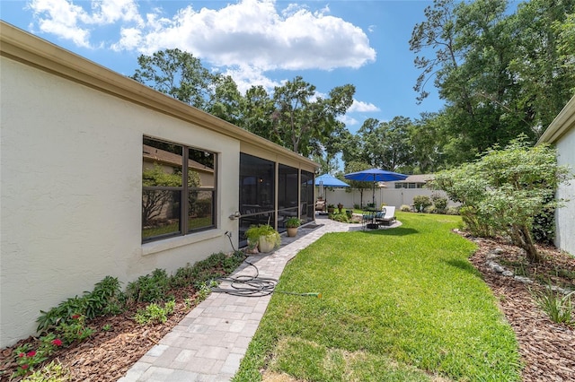 view of yard featuring fence and a sunroom