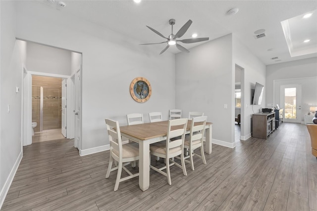 dining room featuring ceiling fan, baseboards, light wood finished floors, and visible vents