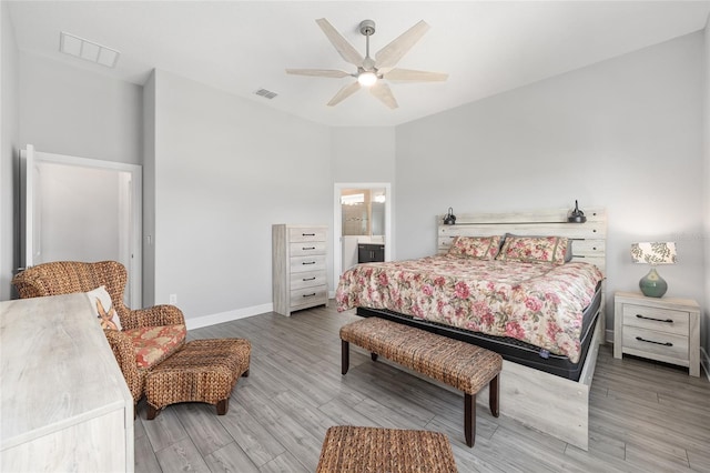 bedroom with wood finished floors, visible vents, baseboards, and ceiling fan