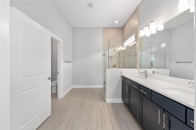 full bath with baseboards, visible vents, a sink, and a shower stall