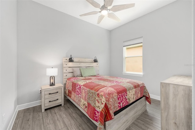 bedroom featuring wood finished floors, baseboards, and ceiling fan