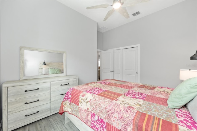 bedroom with lofted ceiling, a closet, a ceiling fan, and visible vents