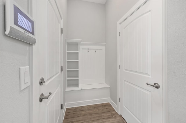 mudroom with baseboards and wood finished floors
