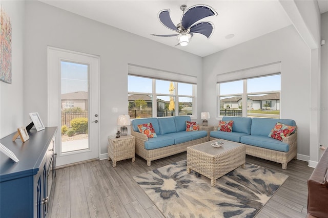 living area featuring ceiling fan, a healthy amount of sunlight, and light wood-style flooring