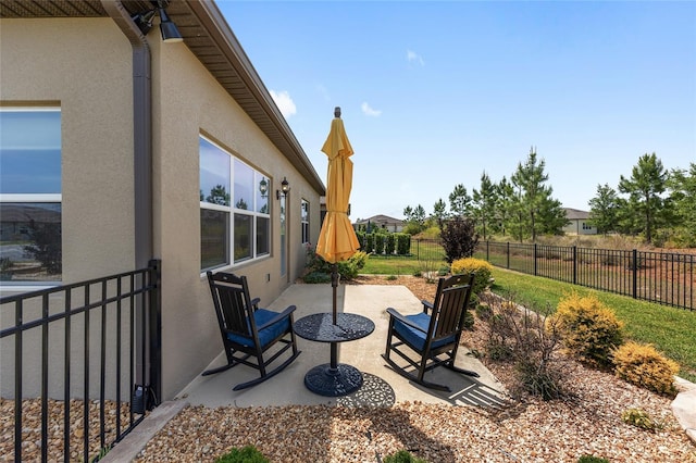 view of patio featuring fence
