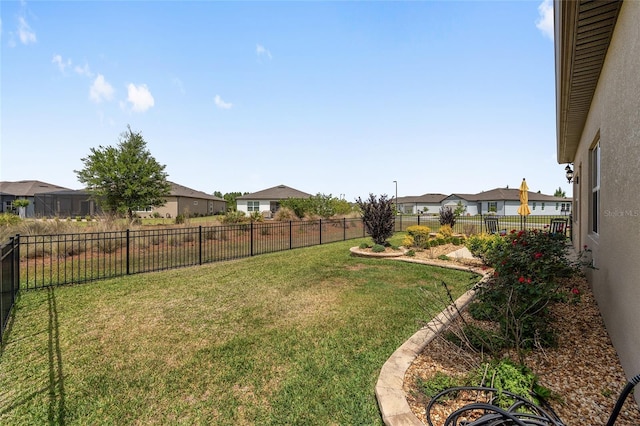 view of yard with a fenced backyard and a residential view