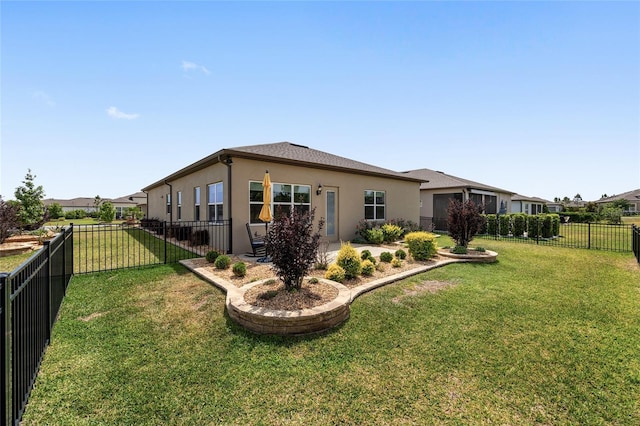 back of property with a yard, a fenced backyard, and stucco siding