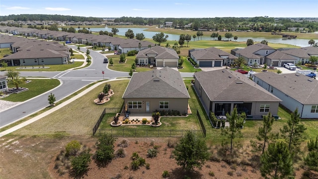 birds eye view of property featuring a water view and a residential view