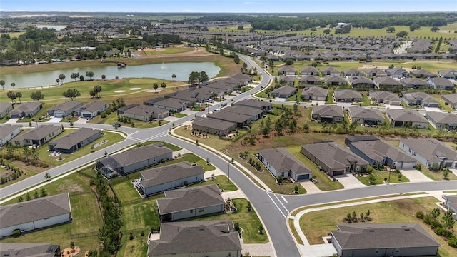 aerial view featuring view of golf course, a residential view, and a water view