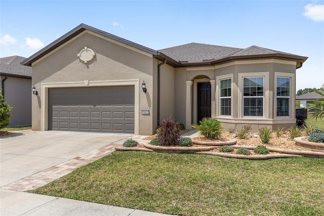 single story home featuring an attached garage, concrete driveway, a front lawn, and stucco siding