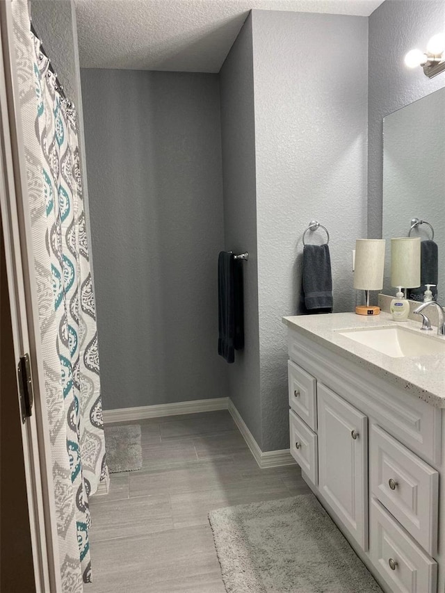 6432 NW 64th Ter, Ocala, FL 34482 - bathroom with vanity, a textured wall, and baseboards