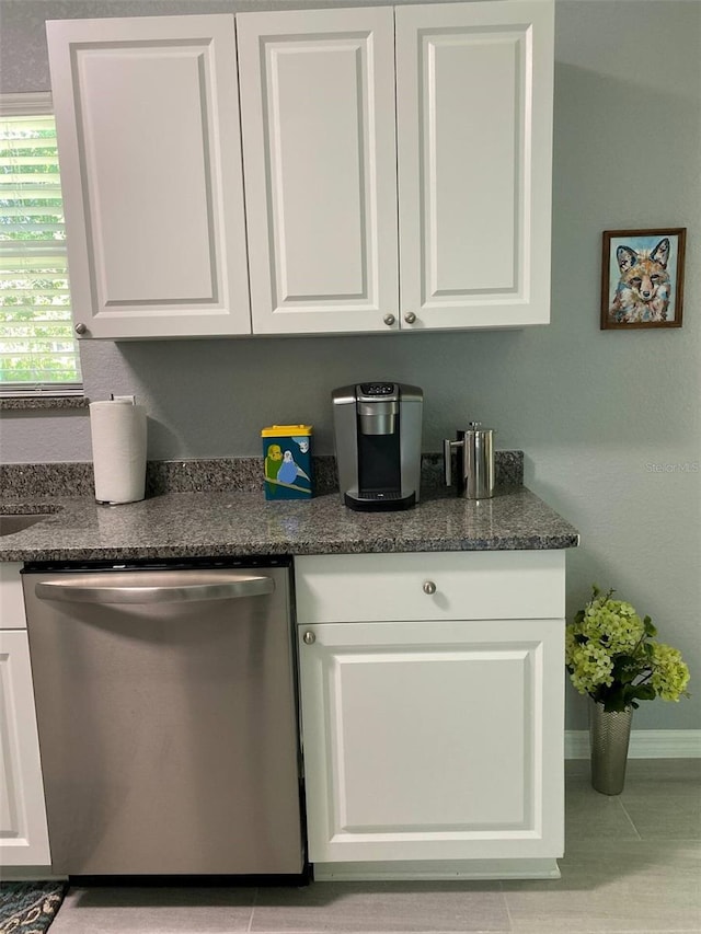 6432 NW 64th Ter, Ocala, FL 34482 - kitchen featuring dishwasher, white cabinetry, baseboards, and dark stone countertops