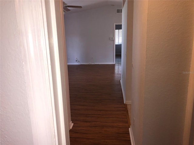 9896 SW 61st Ct, Ocala, FL 34476 - corridor featuring visible vents, a textured wall, wood finished floors, baseboards, and vaulted ceiling