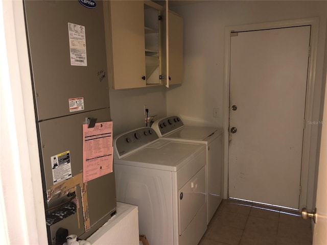9896 SW 61st Ct, Ocala, FL 34476 - laundry room with heating unit, washing machine and dryer, cabinet space, and light tile patterned flooring