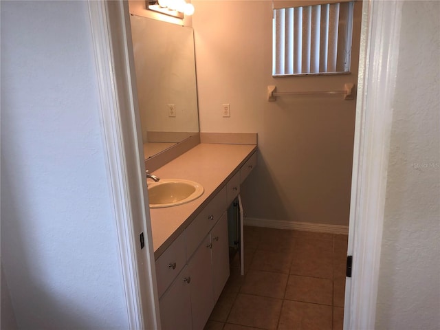 9896 SW 61st Ct, Ocala, FL 34476 - bathroom featuring tile patterned flooring, baseboards, and vanity