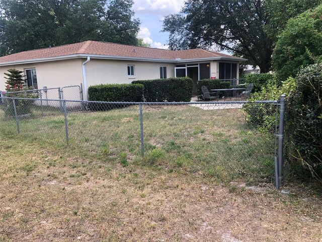 9896 SW 61st Ct, Ocala, FL 34476 - view of front facade with stucco siding, a front lawn, and fence