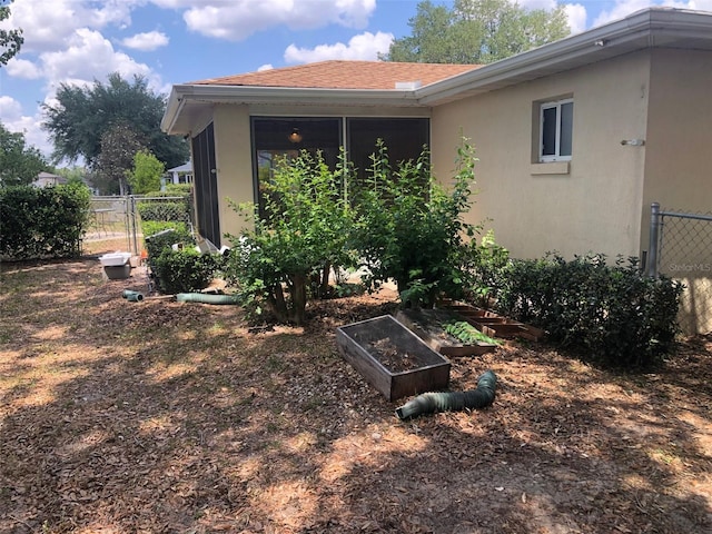 9896 SW 61st Ct, Ocala, FL 34476 - exterior space featuring stucco siding, a garden, and fence