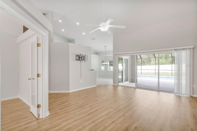 unfurnished living room with baseboards, light wood-style flooring, high vaulted ceiling, and ceiling fan