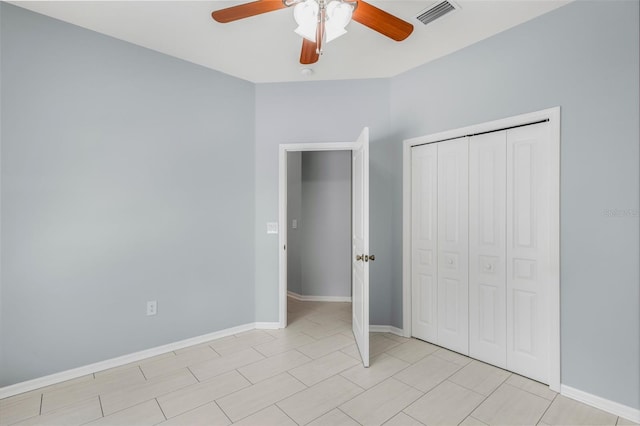 unfurnished bedroom with a closet, visible vents, baseboards, and ceiling fan