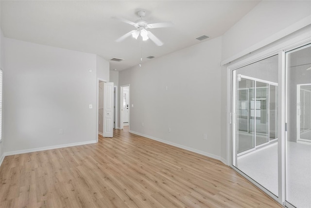 unfurnished room with baseboards, a ceiling fan, visible vents, and light wood-style flooring