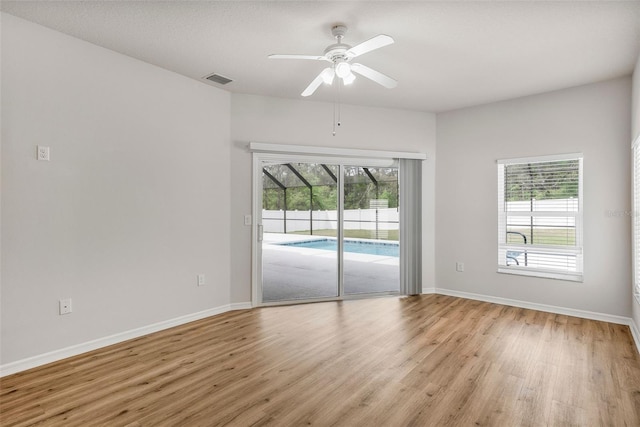 unfurnished room with light wood-style flooring, baseboards, and ceiling fan