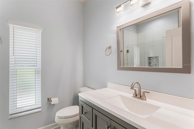 full bath with vanity, a shower with shower door, and toilet