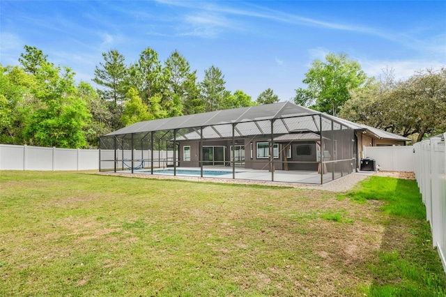 back of house featuring a patio area, a fenced in pool, a lawn, and a fenced backyard